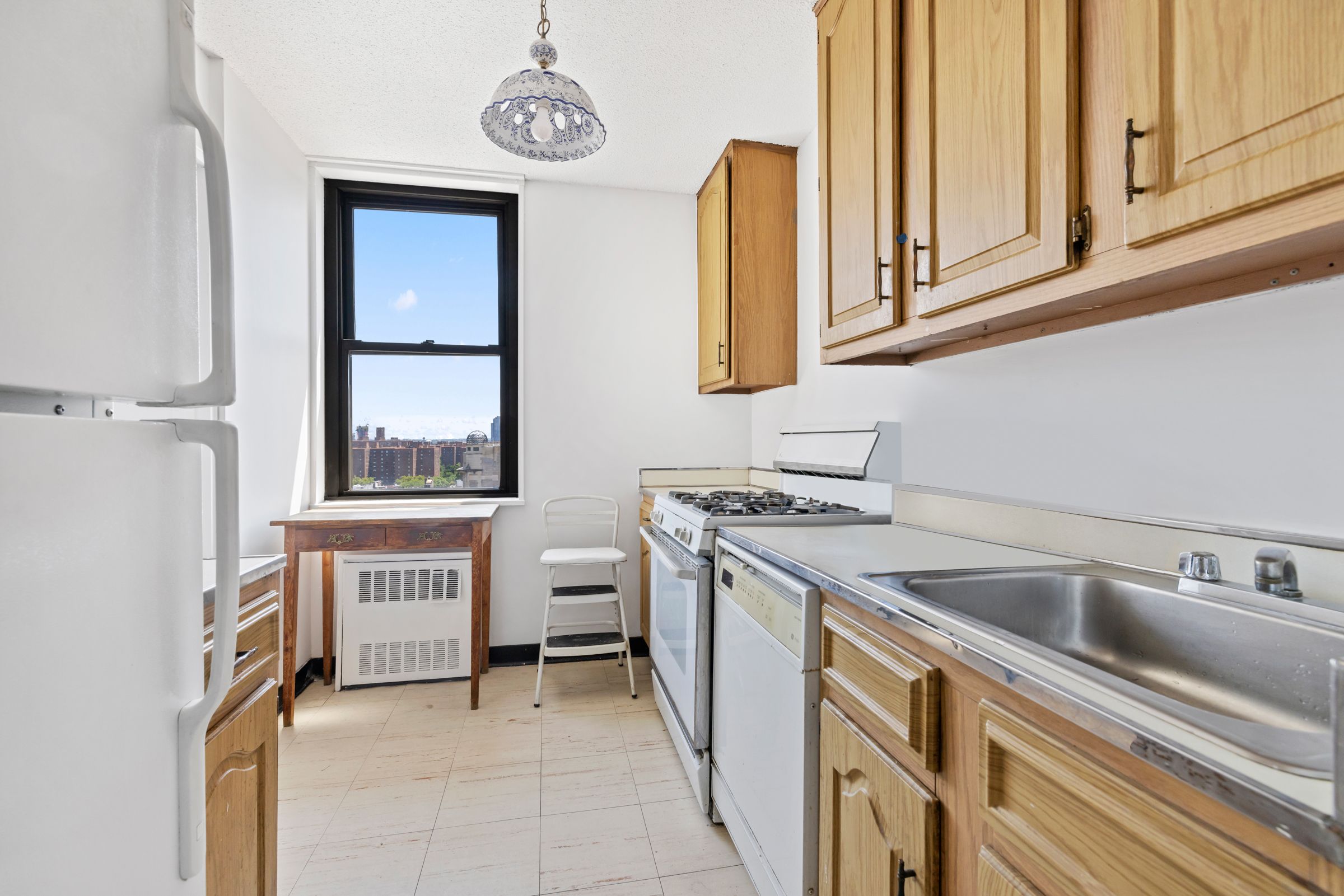 201 East 17th Street, Unit 15H Manhattan, NY 10003 - Photo 10 of 24 a kitchen with a stove and a sink