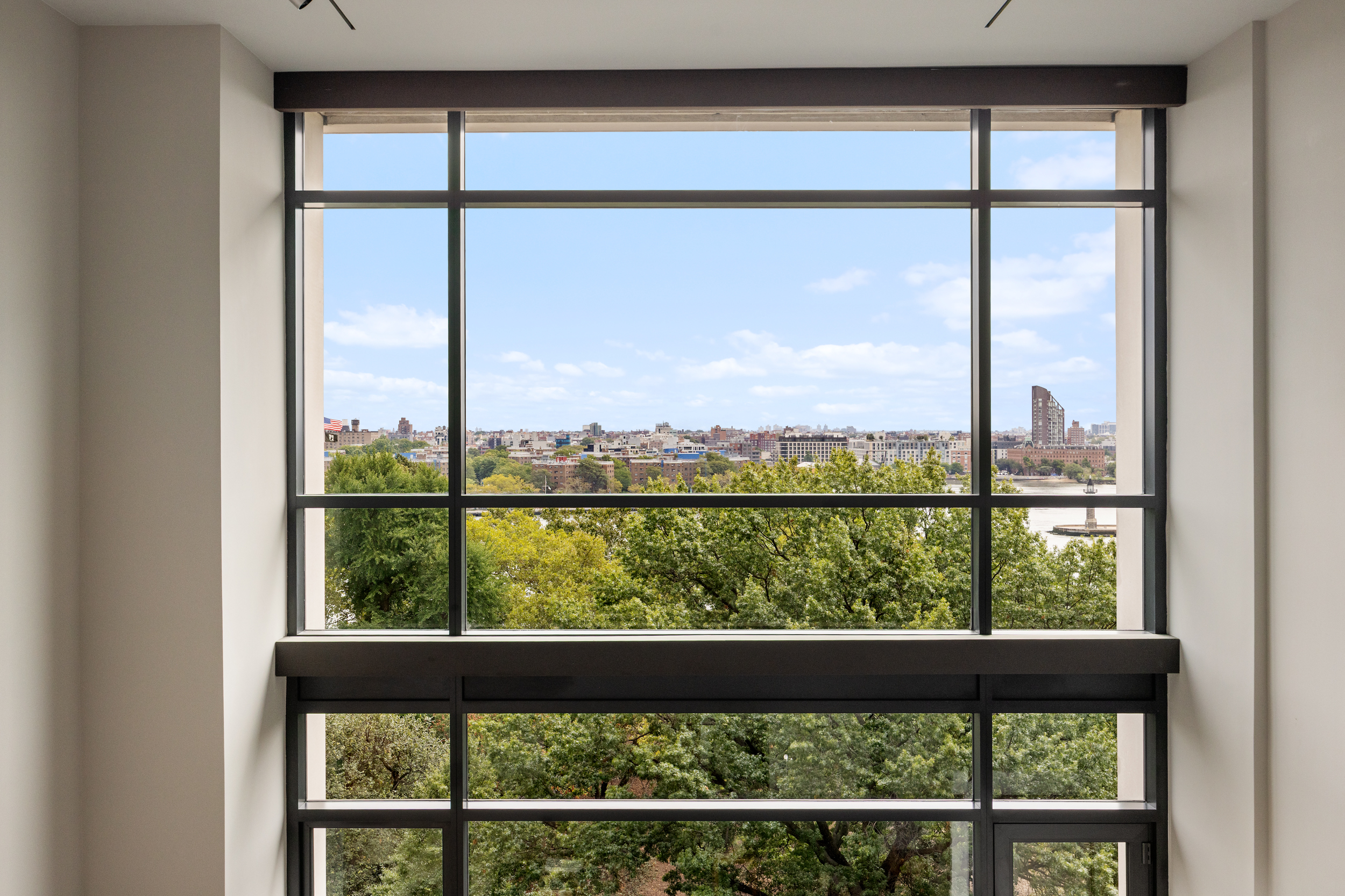 170 East End Avenue, Unit 8EF Manhattan, NY 10128 - Photo 20 of 34 a view of a glass door with a tree in the background