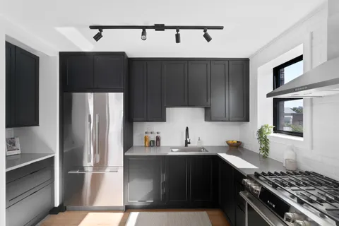 a kitchen with a sink and a refrigerator