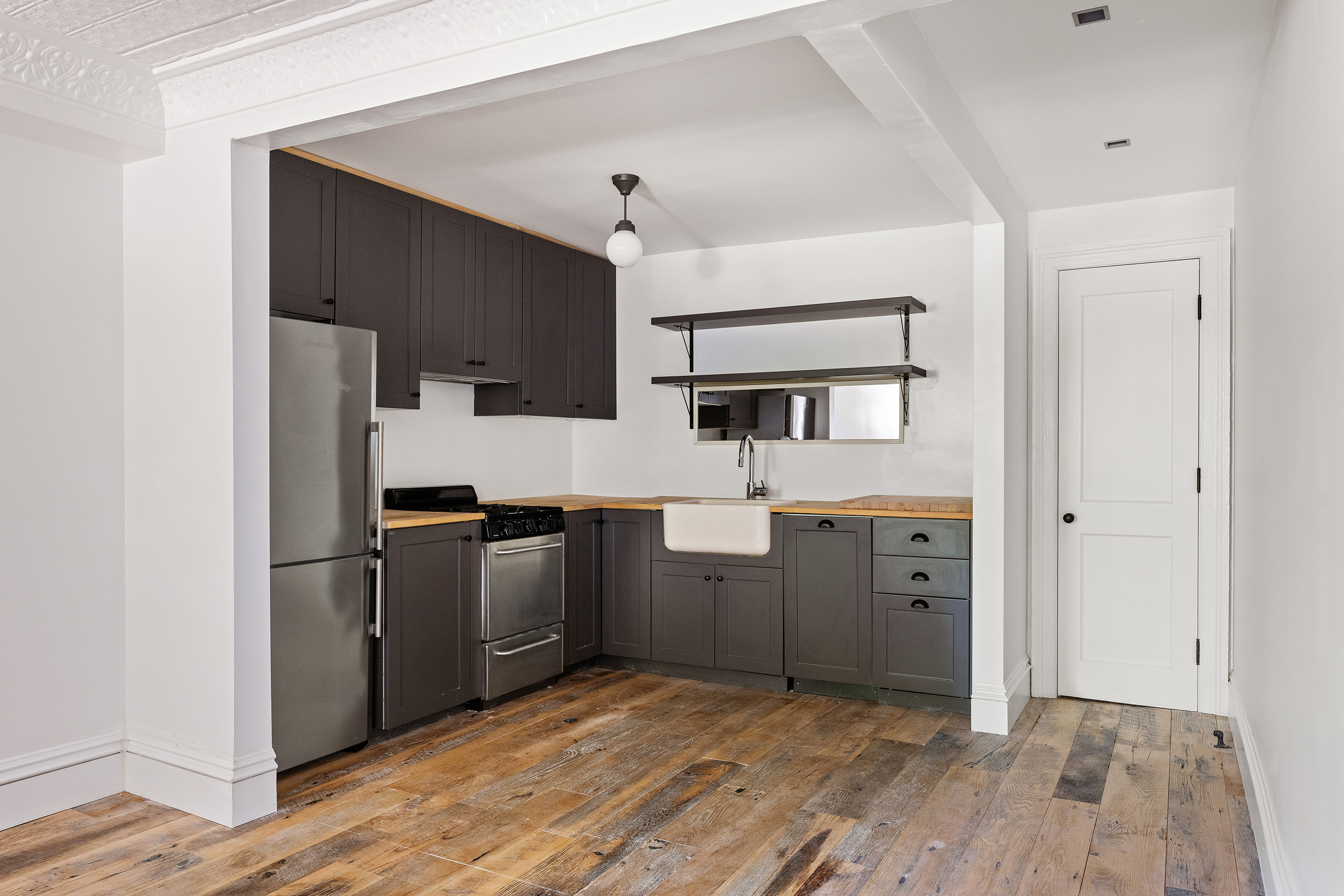 121 St James Place, Unit GARDEN Brooklyn, NY 11238 - Photo 3 of 8 a kitchen with stainless steel appliances a refrigerator and a stove top oven