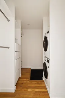 a view of entryway and hall with wooden floor
