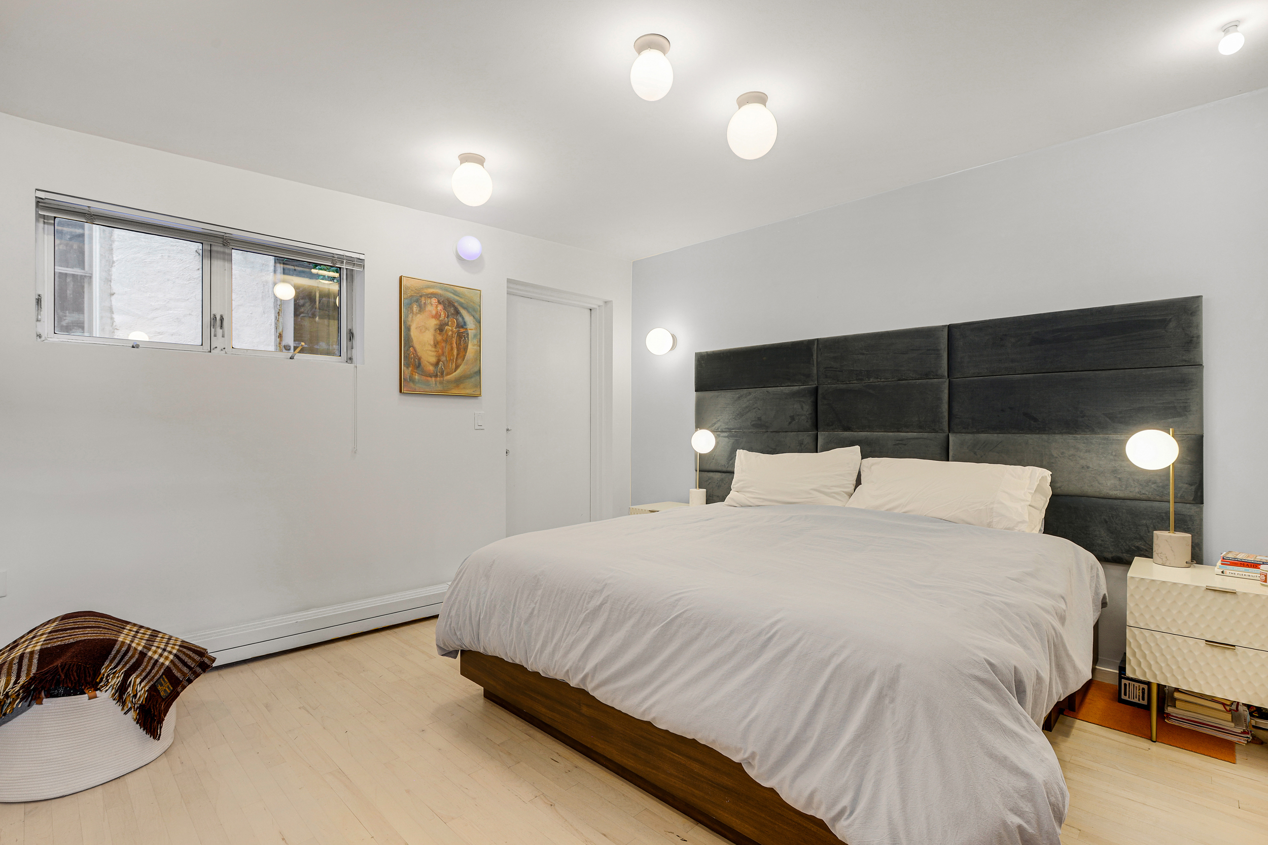 56 Bergen Street, Unit 1R Brooklyn, NY 11201 - Photo 5 of 13 a bedroom with a bed a lamp and a chandelier