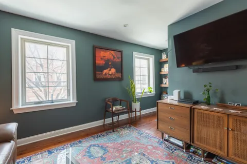 a bed room with furniture and a flat screen tv