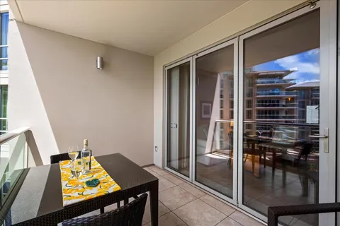 a view of a dining room with a table and chairs