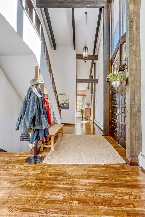 a living room with furniture and floor to ceiling windows