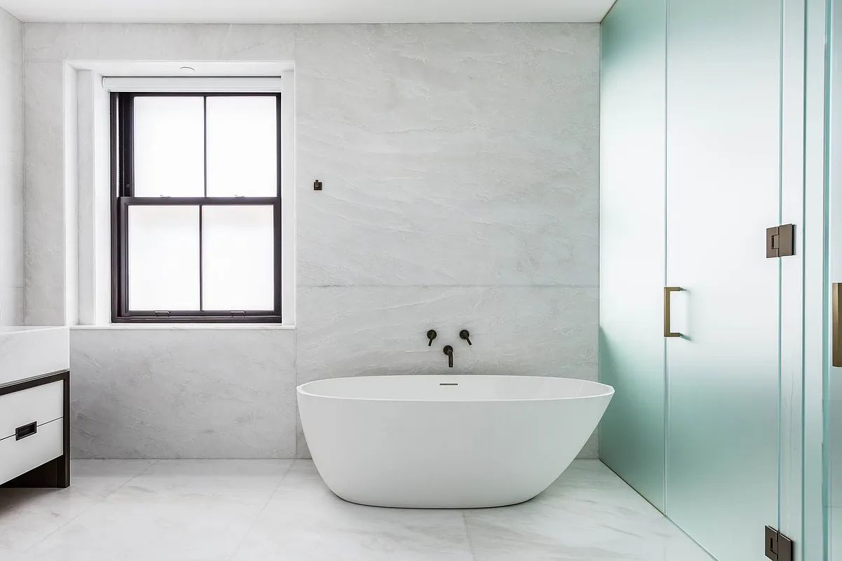 a white bath tub sitting next to a window