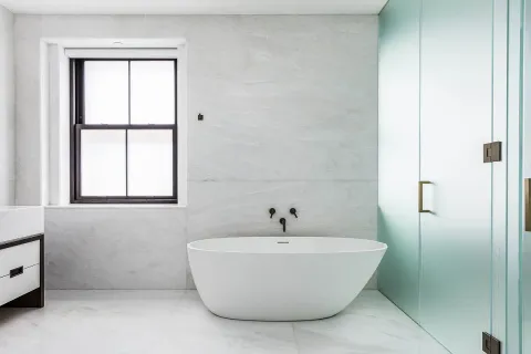 a white bath tub sitting next to a window