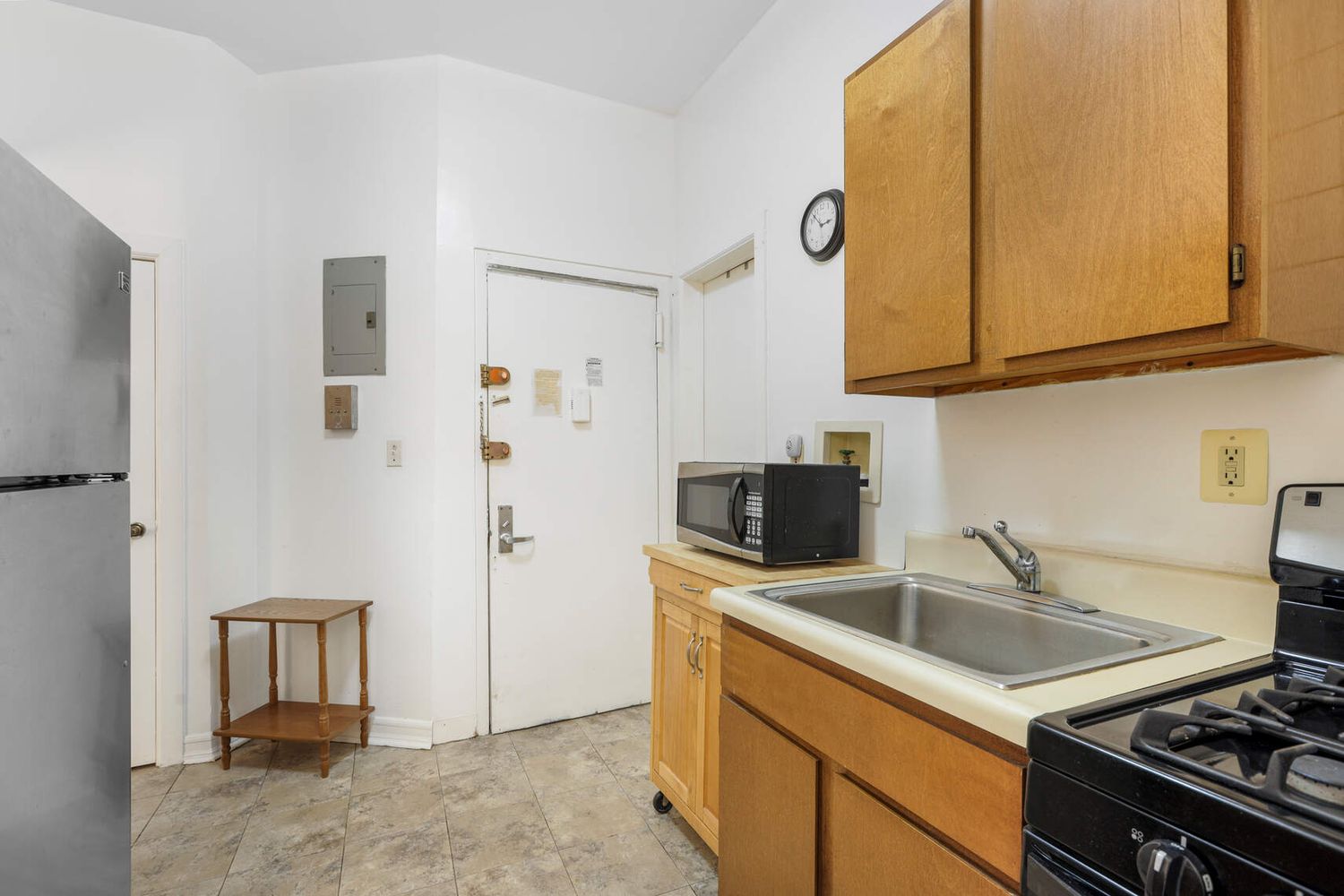 a kitchen with stainless steel appliances a stove a sink and a microwave