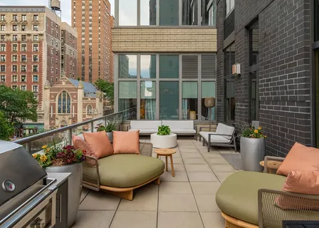 a view of a patio with couches table and chairs and potted plants