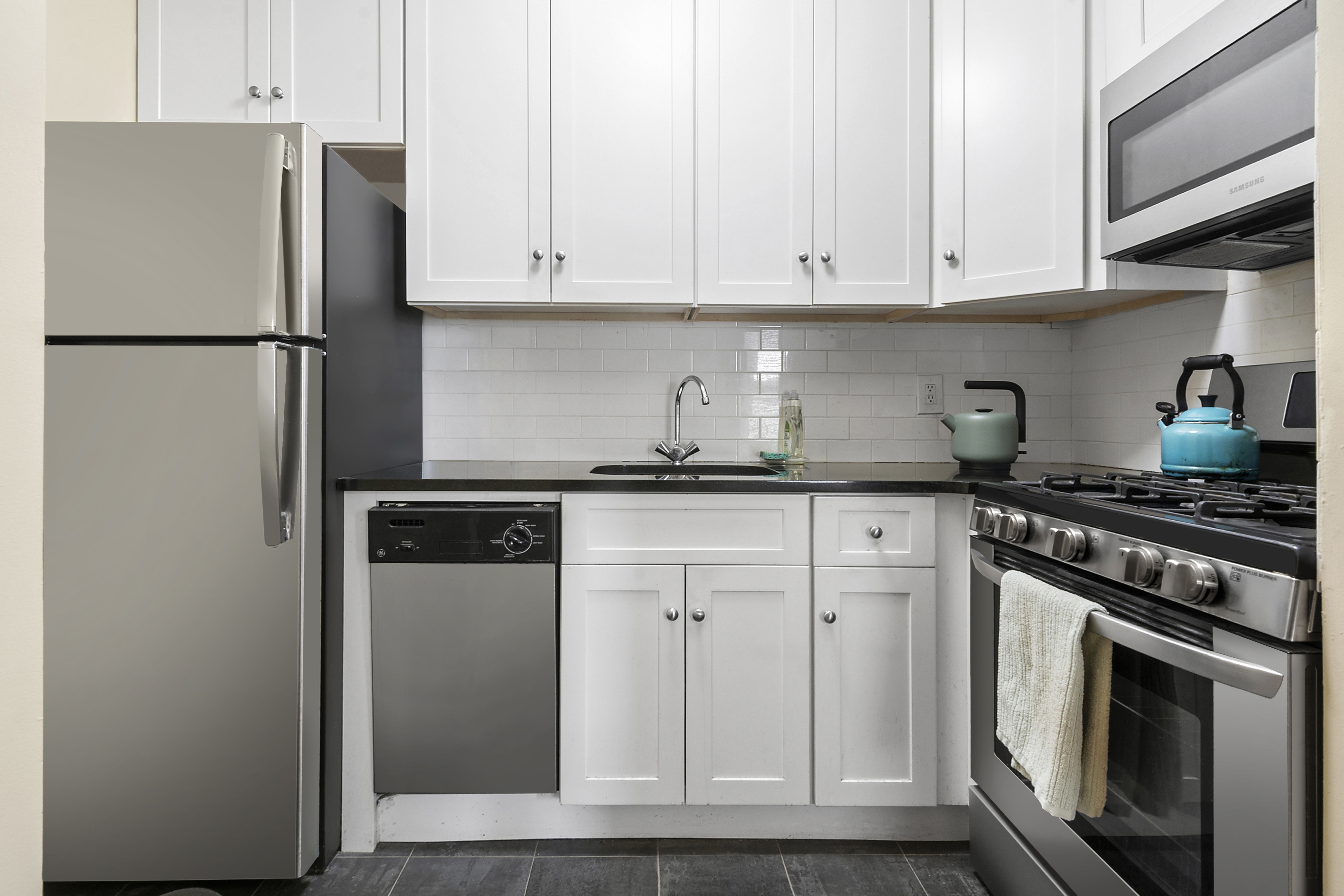 680 81st Street, Unit 3D Brooklyn, NY 11228 - Photo 4 of 5 a kitchen with cabinets stainless steel appliances and a counter space