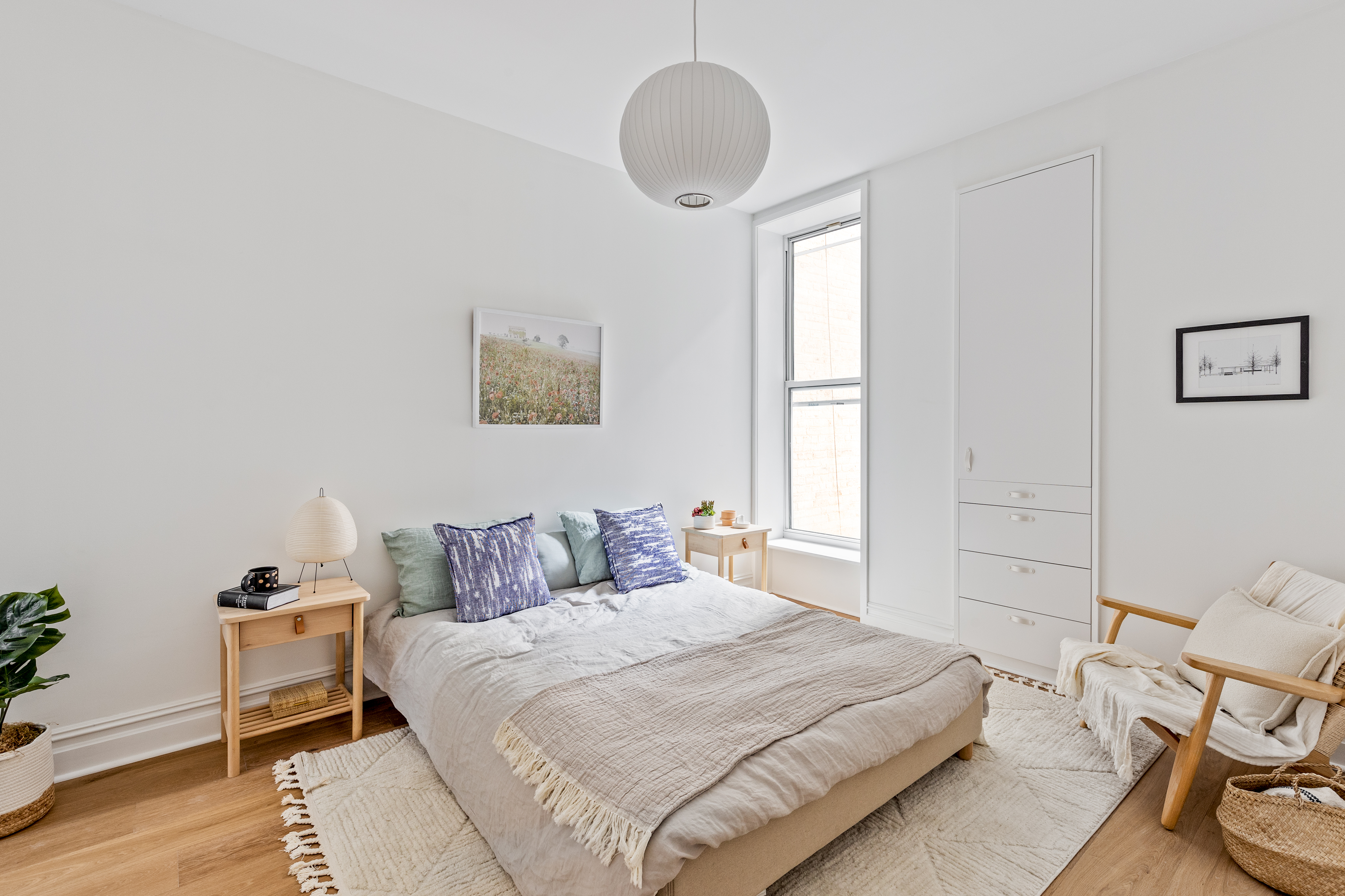 744 Park Place, Unit 3B Brooklyn, NY 11216 - Photo 4 of 10 a bedroom with a bed and wooden floor