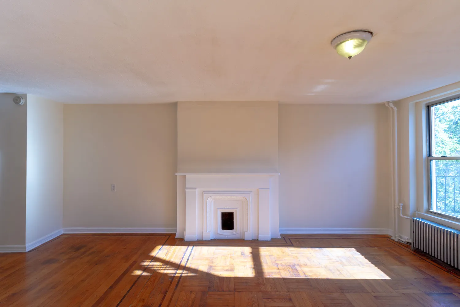 a view of a livingroom with a fireplace and window