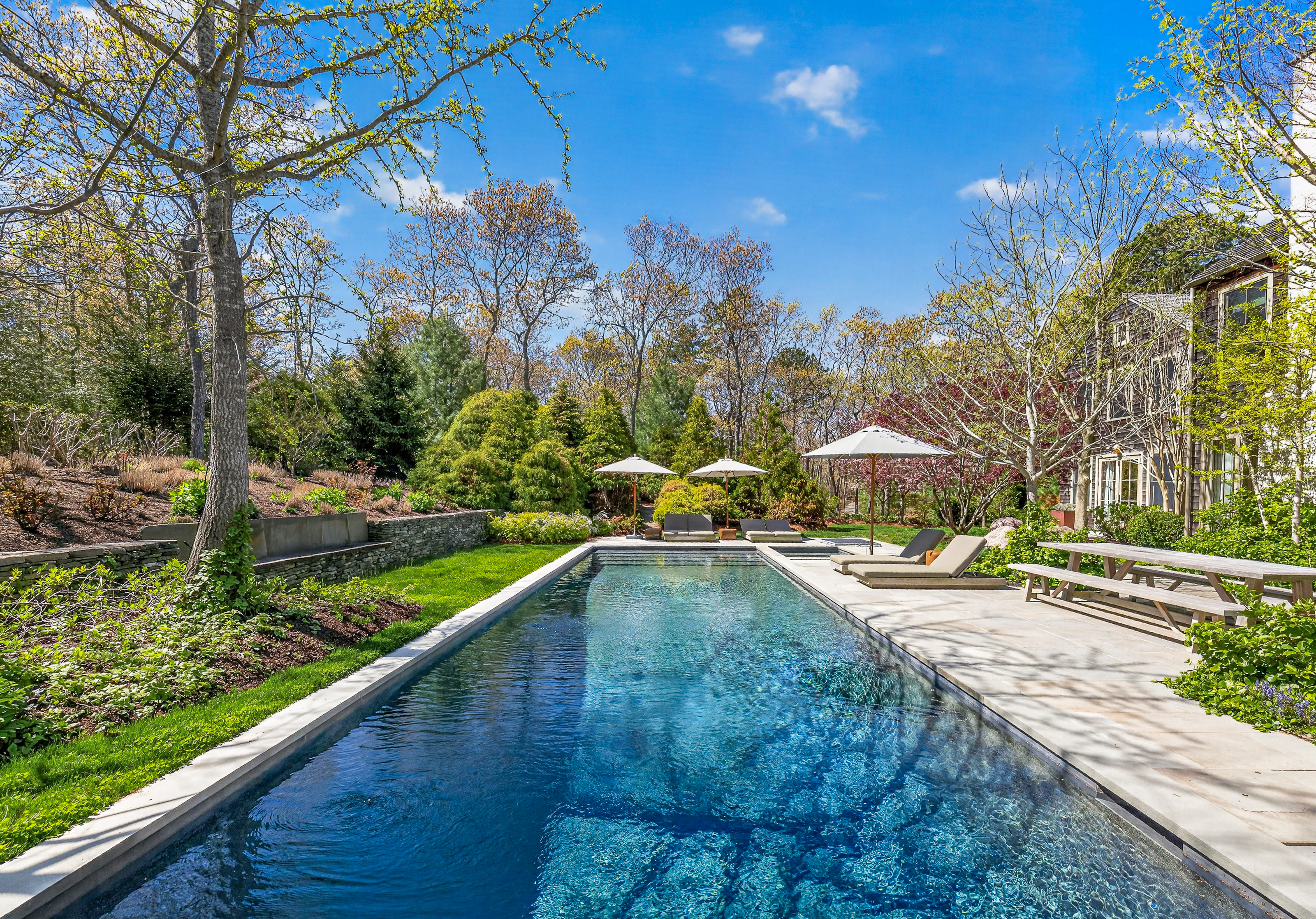 102 & 104 Two Holes Water Road East Hampton, NY 11937 - Photo 34 of 48 a view of a swimming pool with a patio