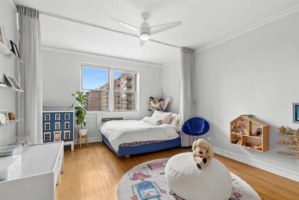 a bedroom with furniture and a wooden floor