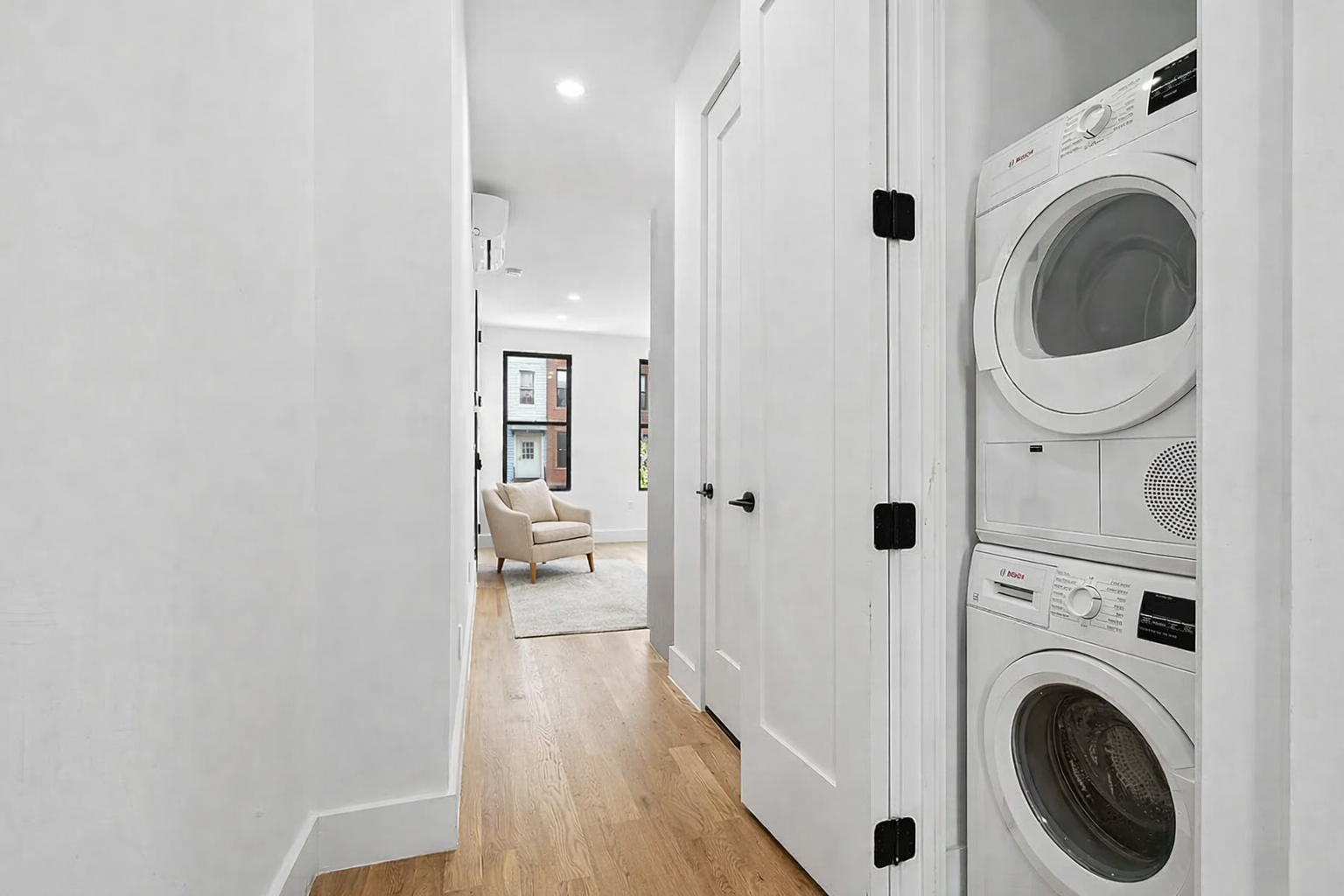 203 Cornelia Street, Unit 2 Brooklyn, NY 11221 - Photo 6 of 9 a view of a hallway with washer and dryer