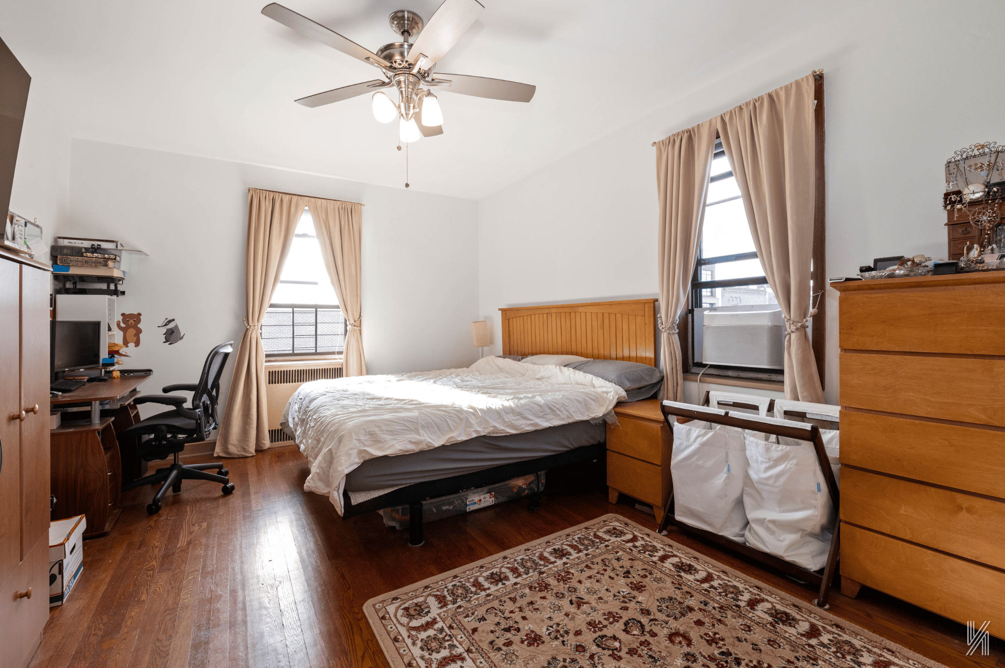 25-40 31st Avenue, Unit 6M Queens, NY 11106 - Photo 9 of 17 a bedroom with a bed and wooden floor