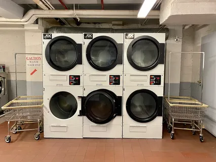 a utility room with dryer washer and a view of kitchen