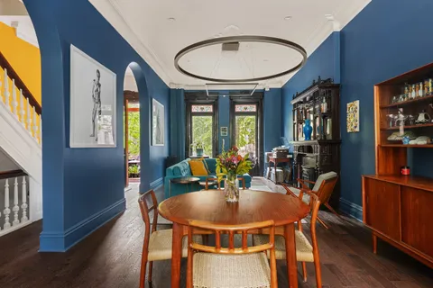 a view of a dining room with furniture window and wooden floor