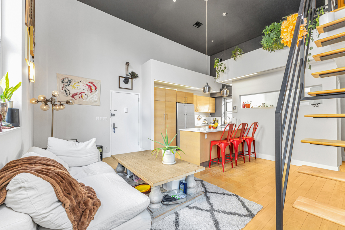 96 Woodpoint Road, Unit 3A Brooklyn, NY 11211 - Photo 4 of 15 a bedroom with furniture and a chandelier