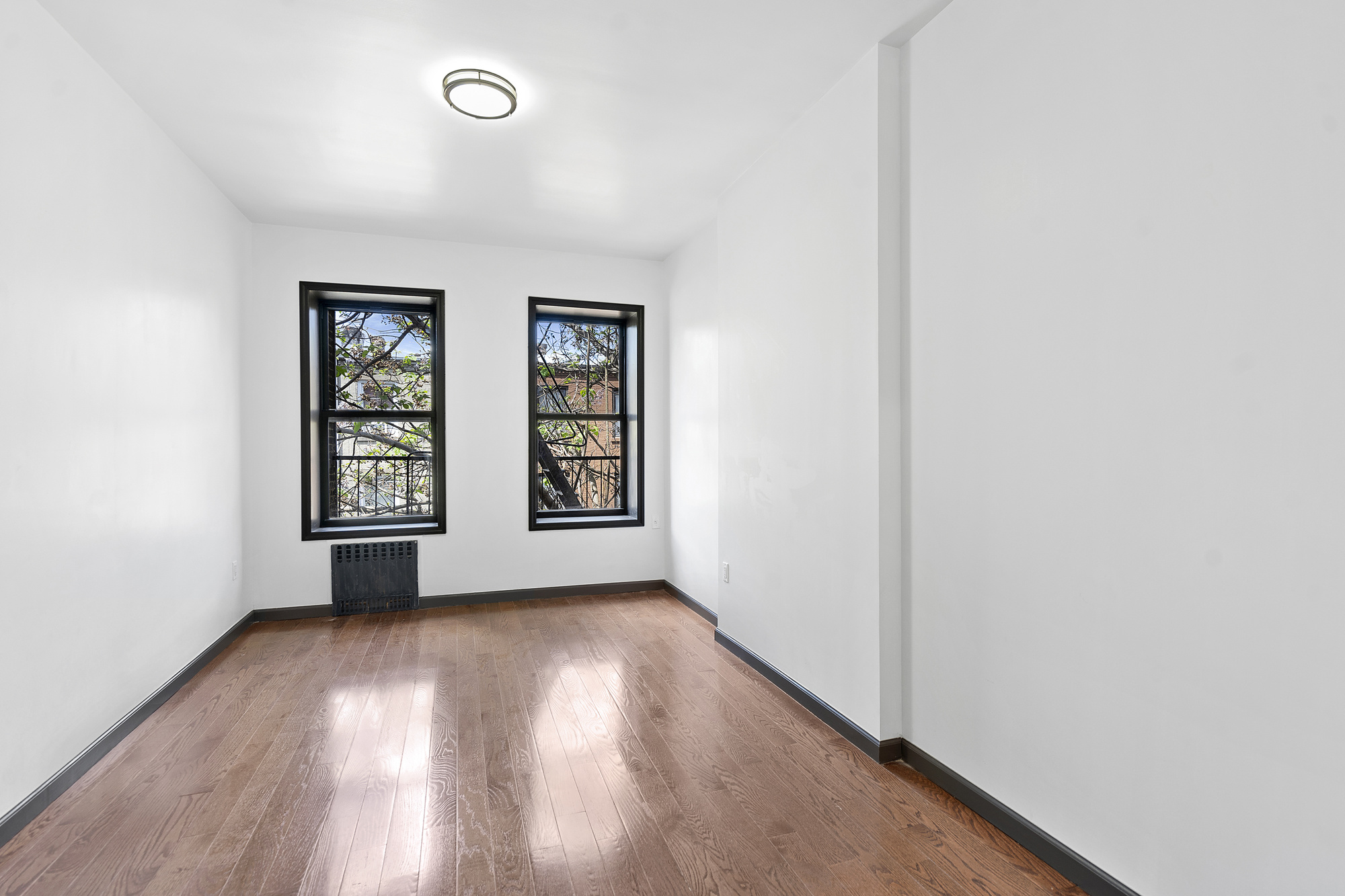 1389 Fulton Street, Unit 3 Brooklyn, NY 11216 - Photo 11 of 12 an empty room with windows