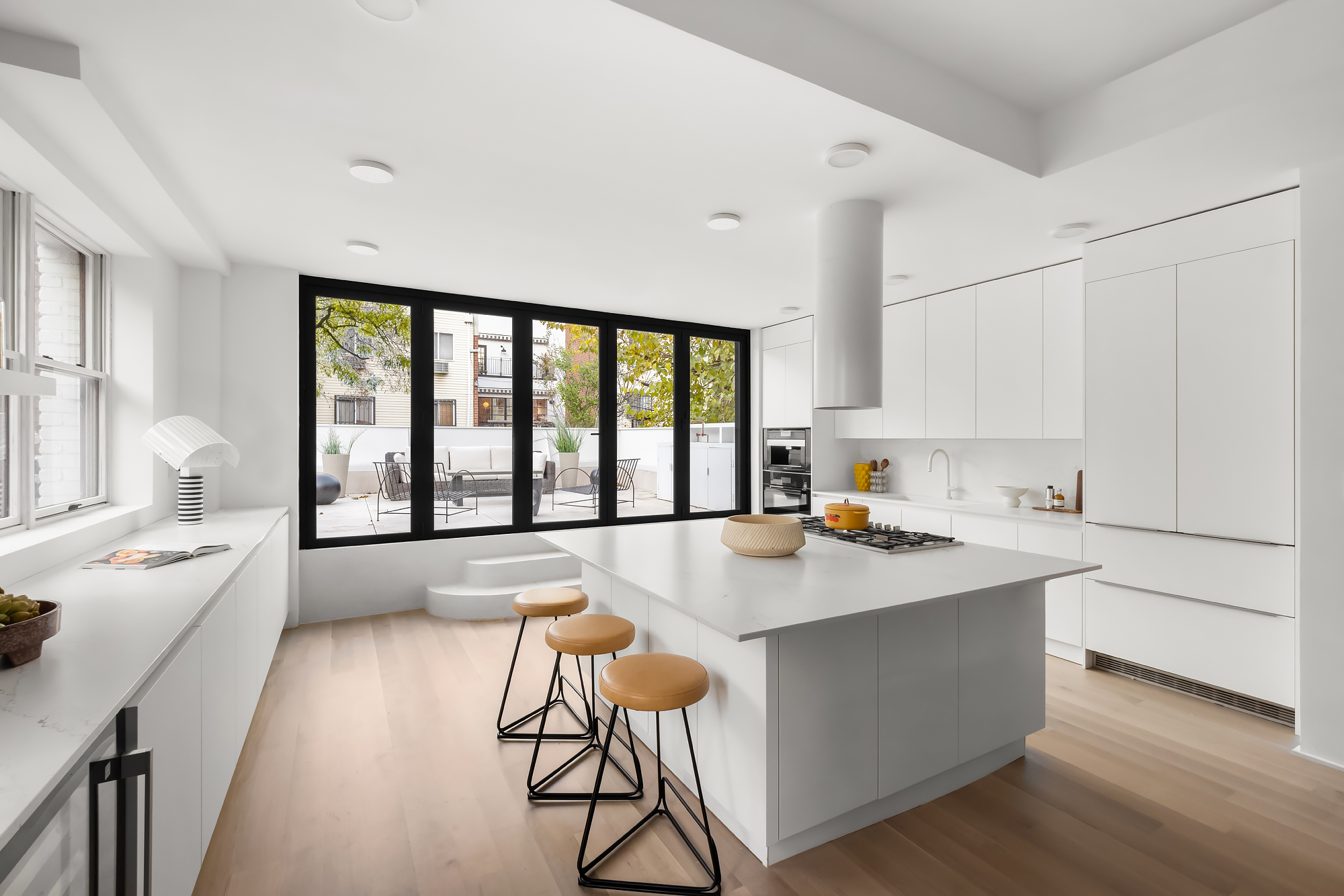 61 South 4th Street Brooklyn, NY 11249 - Photo 3 of 29 a open kitchen with stainless steel appliances granite countertop a stove a sink and white cabinets with wooden floor