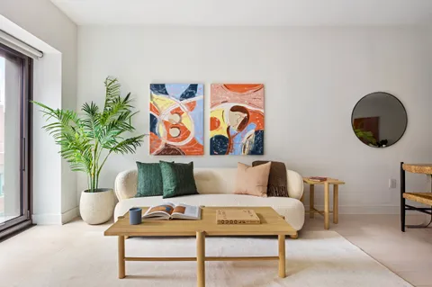 a living room with furniture and a potted plant