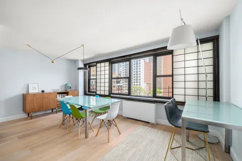 a dining room with furniture and wooden floor