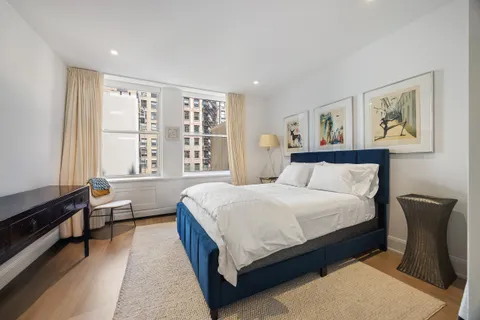 a bedroom with a bed a couch and a window