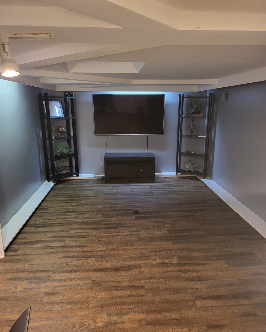 6337 Roosevelt Road, Unit 105 Berwyn, IL 60402 - Photo 5 of 21 a view of empty room with wooden floor and a fireplace