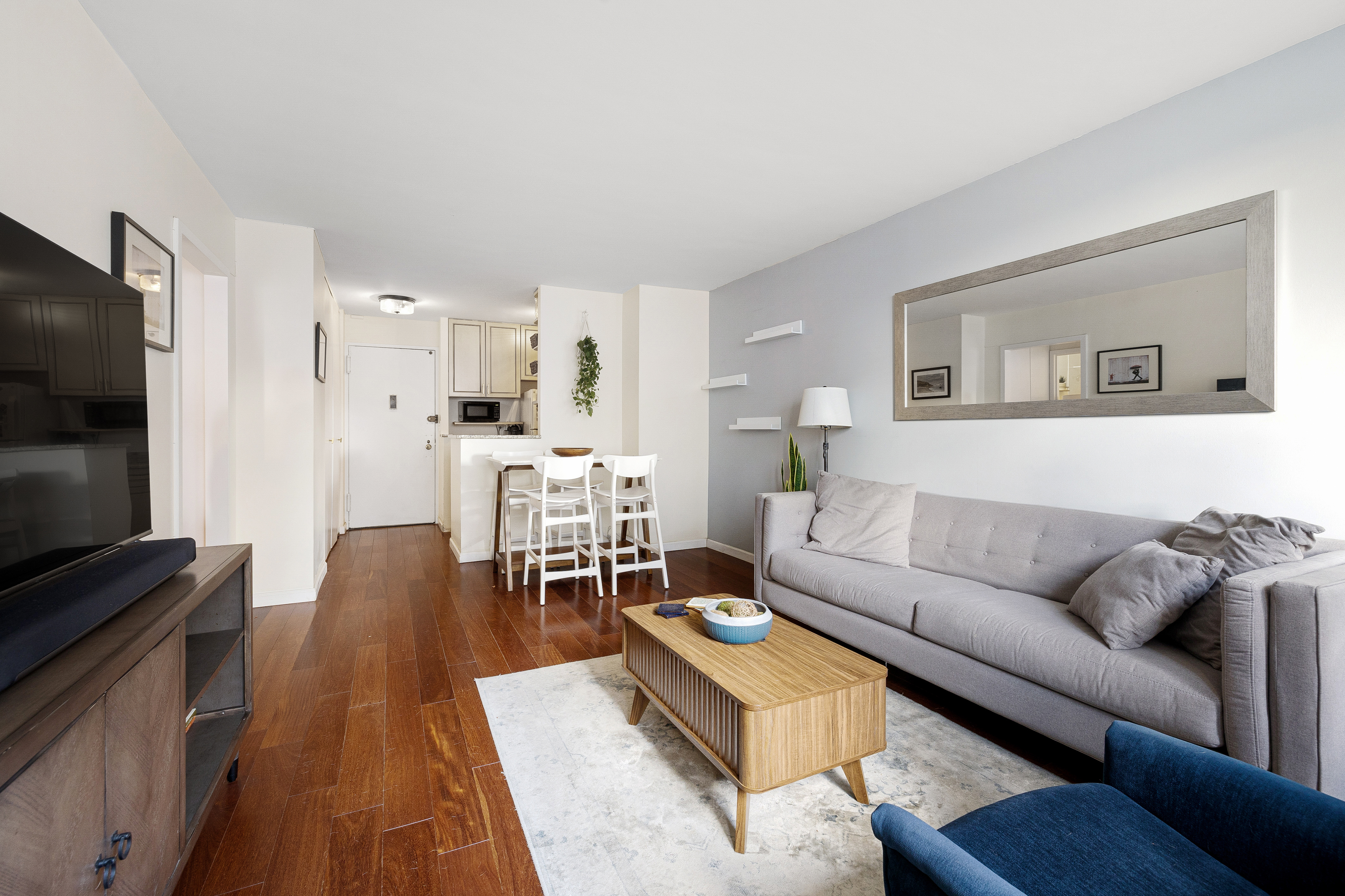 2025 Broadway, Unit 9F Manhattan, NY 10023 - Photo 3 of 11 a living room with furniture and a flat screen tv