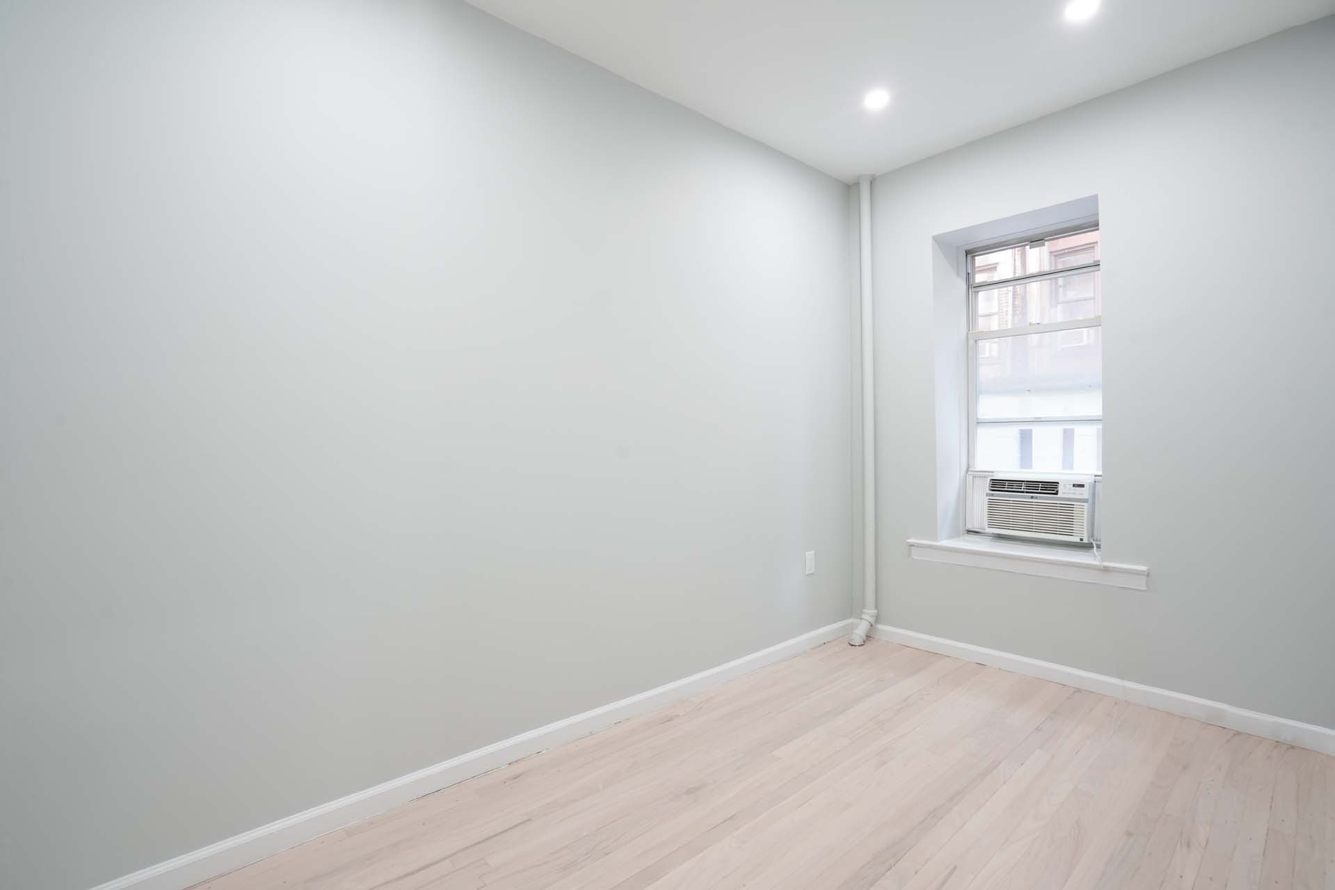 210 West 10th Street, Unit 1C Manhattan, NY 10014 - Photo 6 of 6 an empty room with windows