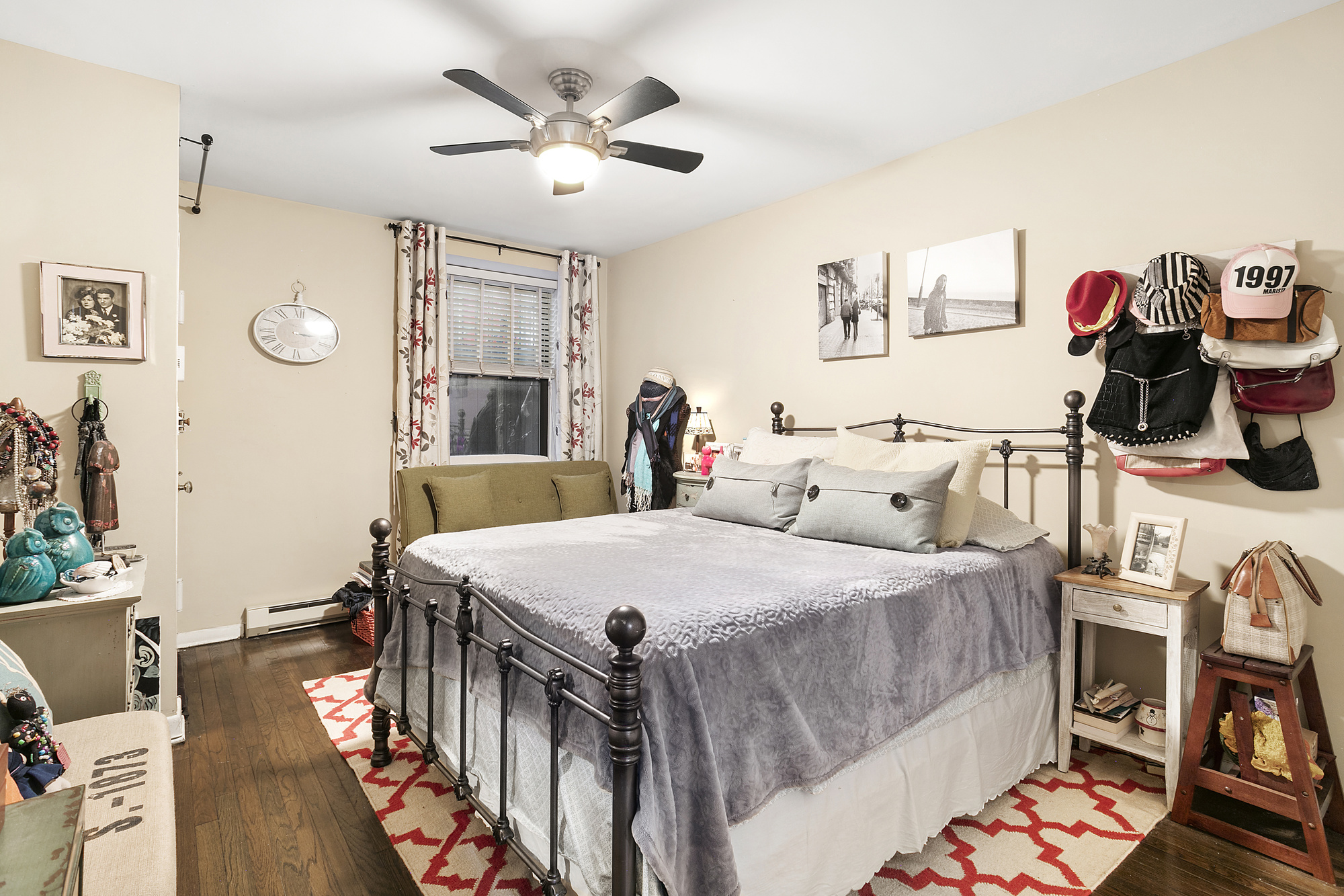 425 West 24th Street, Unit 1E Manhattan, NY 10011 - Photo 3 of 5 a bedroom with a bed and a chandelier