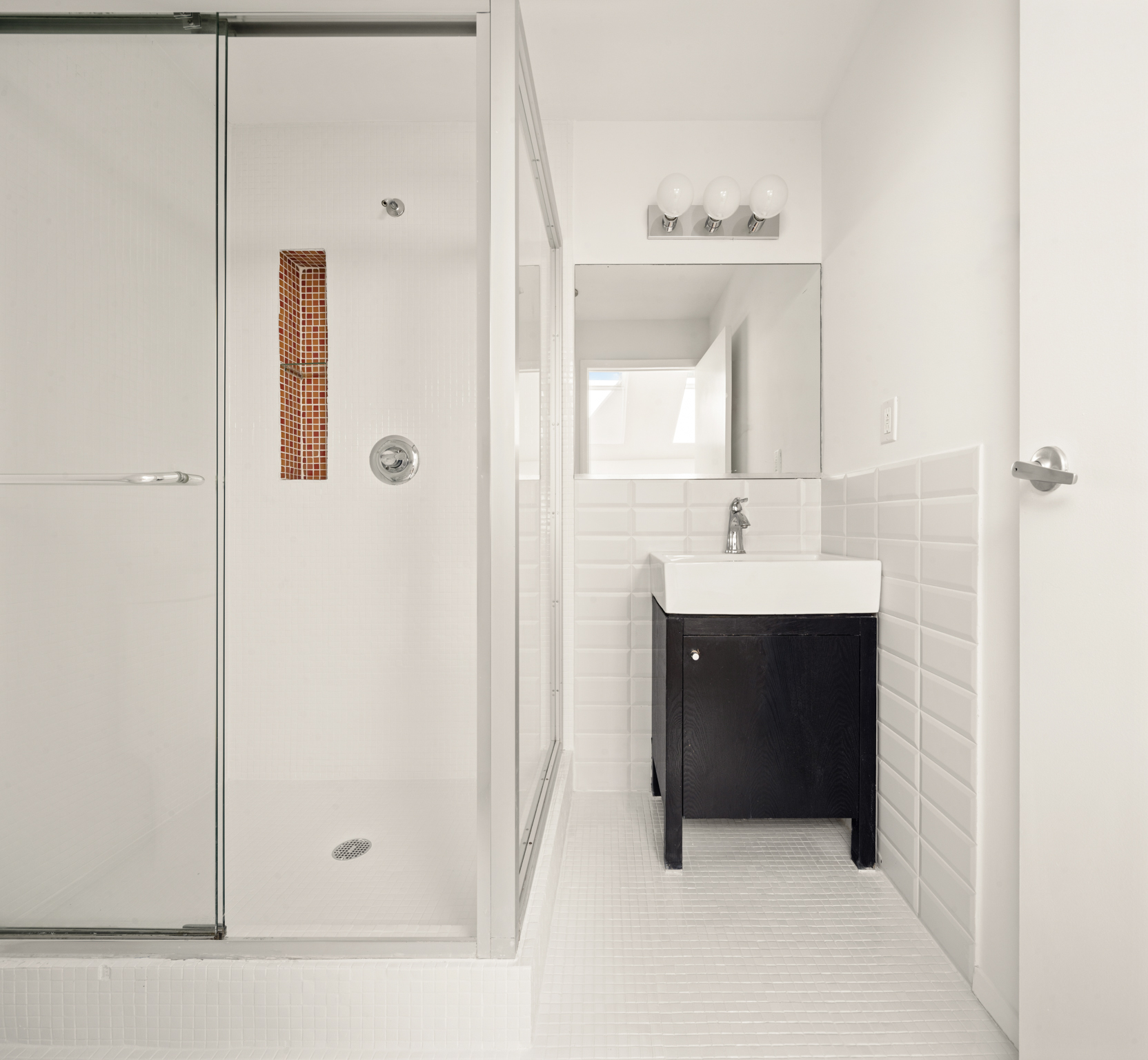 433 Warren Street, Unit 4A Brooklyn, NY 11217 - Photo 7 of 10 a bathroom with a sink and a mirror