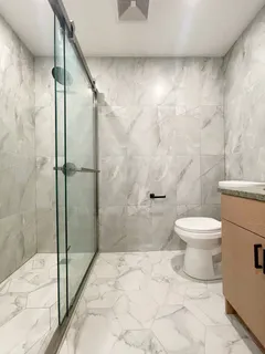 a bathroom with a toilet and a shower