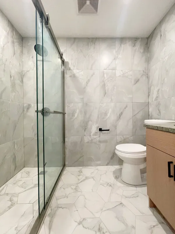 a bathroom with a toilet and a shower