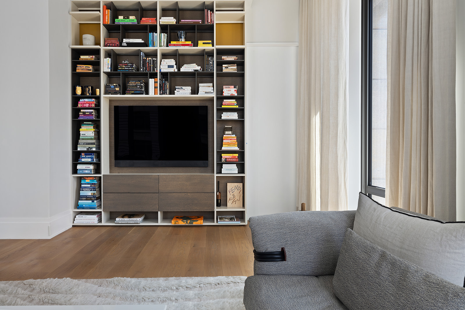 601 Washington Street, Unit 3W Manhattan, NY 10014 - Photo 5 of 15 a living room with furniture and a book shelf
