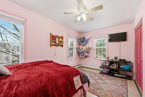 a bed sitting in a bedroom next to a window