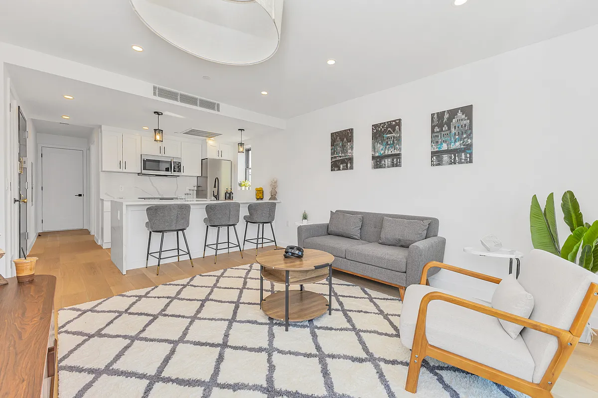 21-10 31st Avenue, Unit 6R Queens, NY 11106 - Photo 4 of 17 a living room with furniture and a table