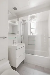 a bathroom with a sink mirror toilet and bathtub