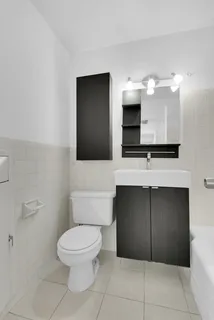 a bathroom with a toilet sink and mirror