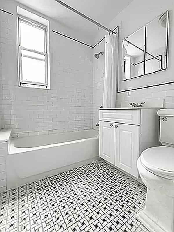 117 West 13th Street, Unit 25 Manhattan, NY 10011 - Photo 3 of 7 a bathroom with a toilet a sink and a bathtub