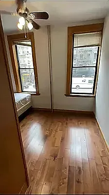 1278 1st Avenue, Unit 5 Manhattan, NY 10065 - Photo 3 of 5 wooden floor in an empty room with a window