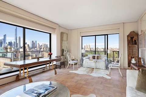 a living room with furniture and floor to ceiling window