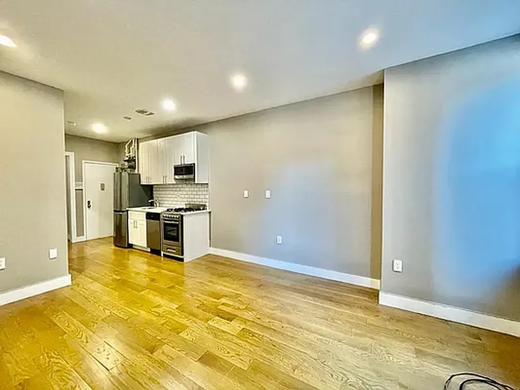 a kitchen with stainless steel appliances a refrigerator and a stove top oven
