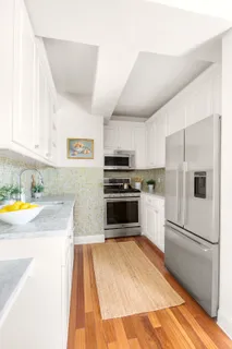 a kitchen with granite countertop a refrigerator and a stove