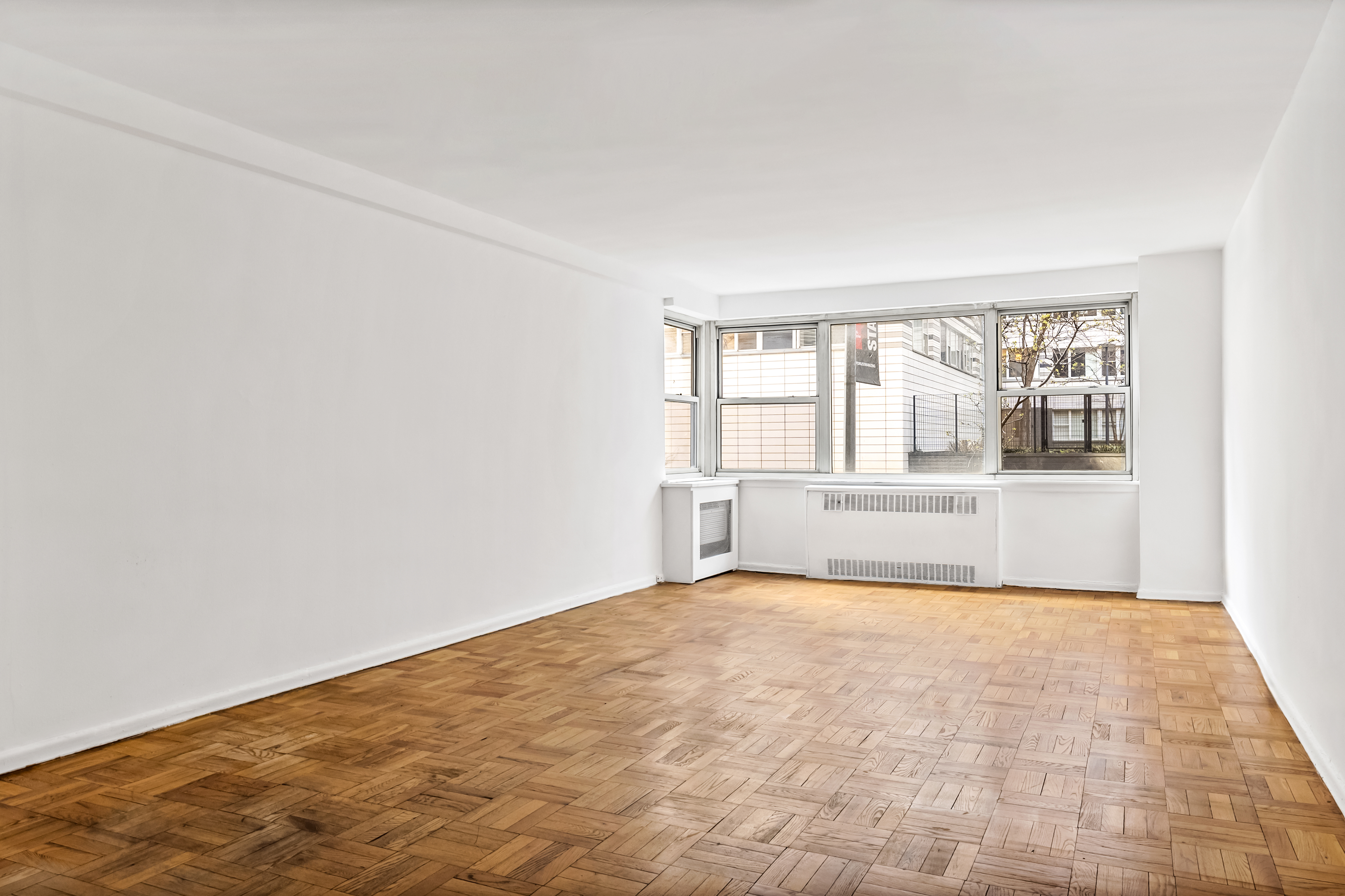 233 East 69th Street, Unit 2C Manhattan, NY 10021 - Photo 5 of 10 a view of an empty room with a window