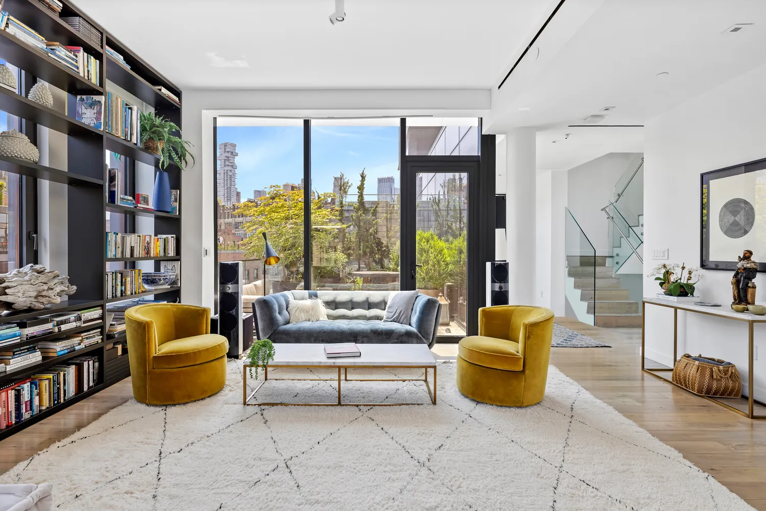 a living room with furniture a rug and a large window