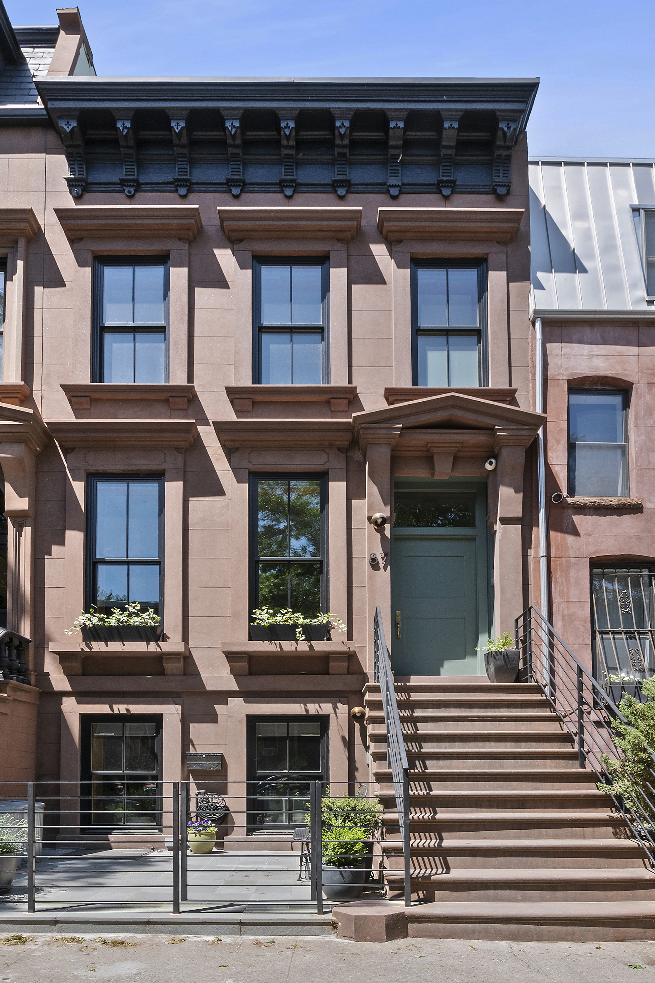 87 Monroe Street Brooklyn, NY 11216 - Photo 24 of 26 a front view of a house with a garage