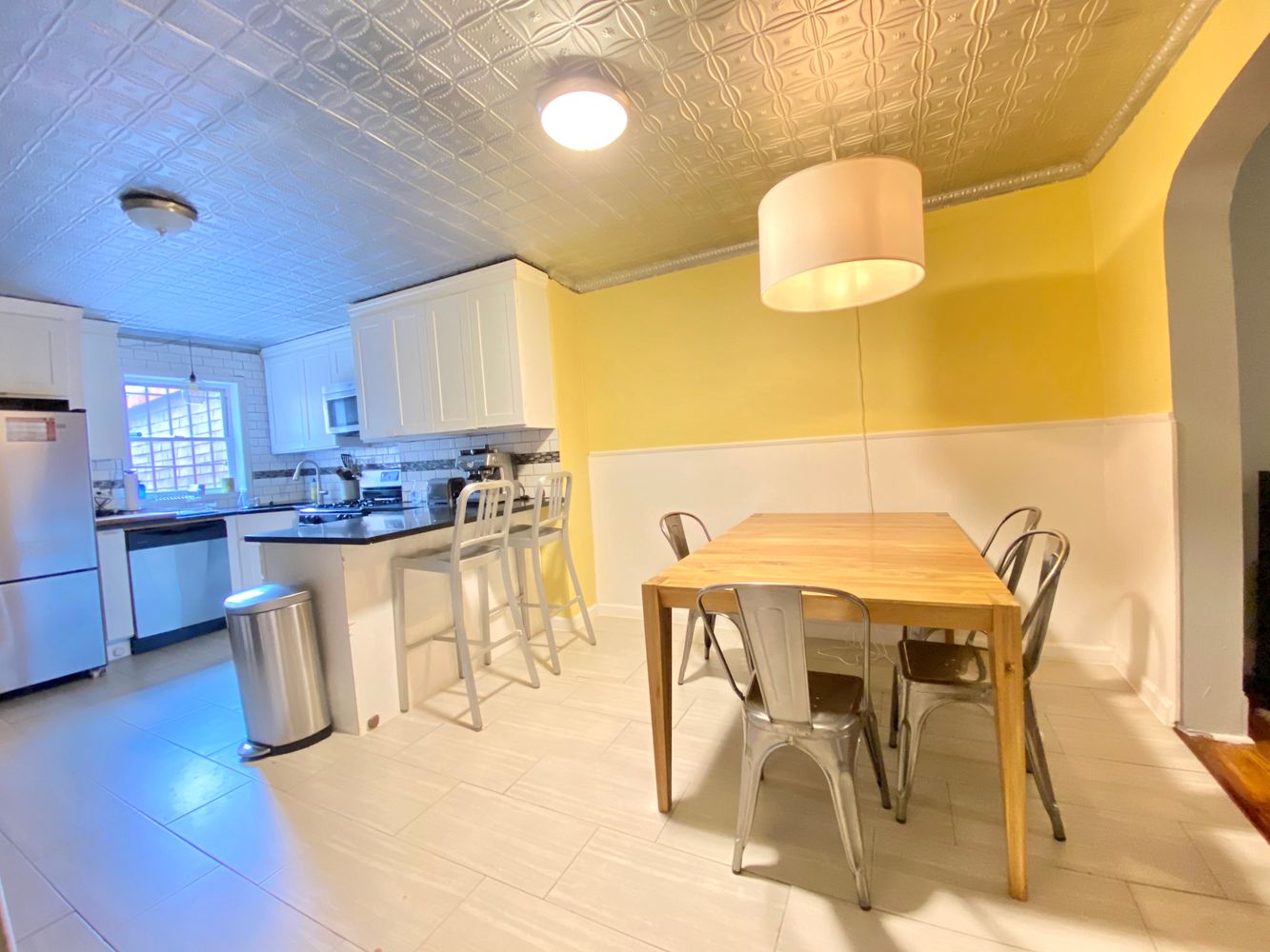 390 5th Street, Unit 1 Brooklyn, NY 11215 - Photo 9 of 15 a kitchen with a table chairs and a refrigerator