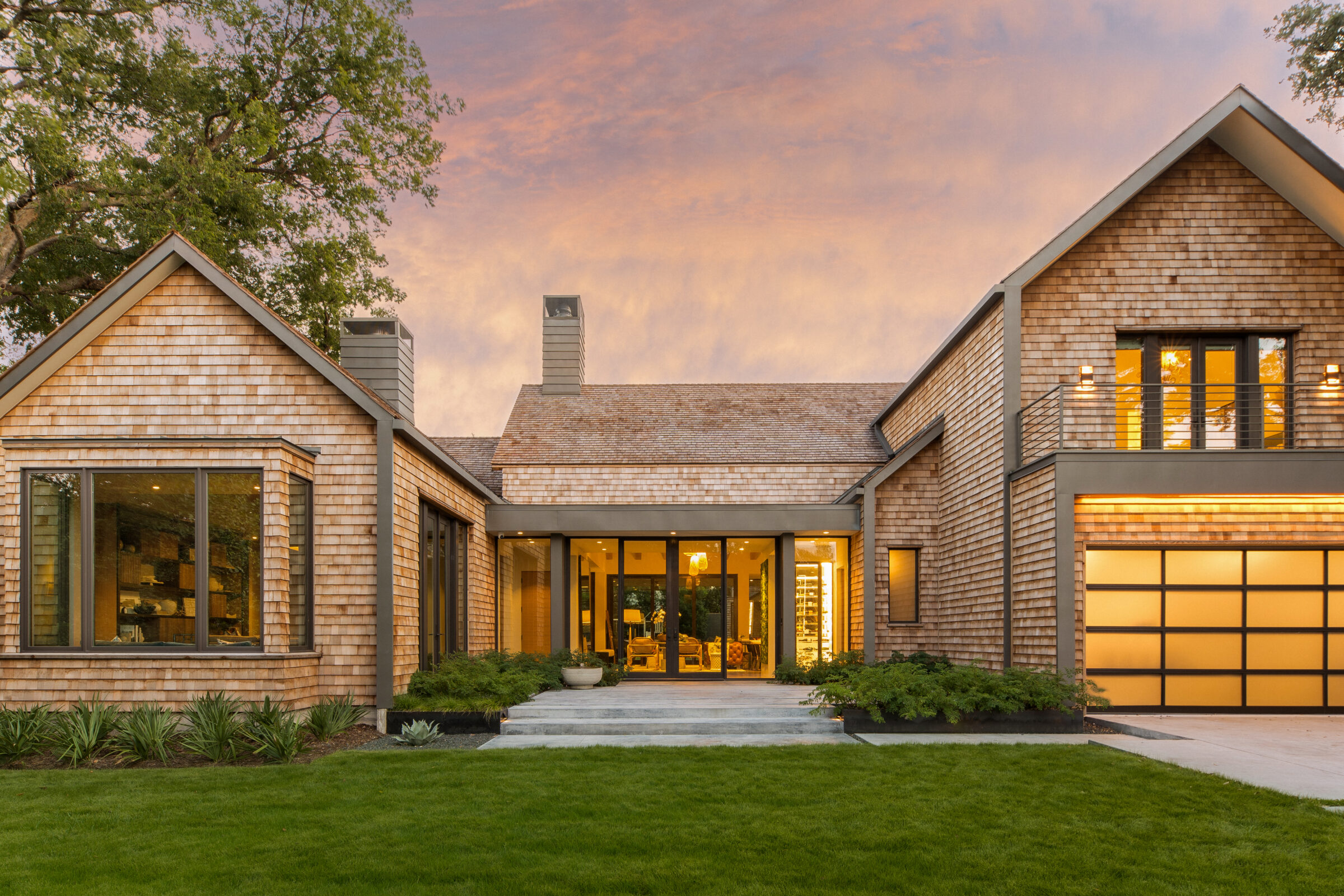 a front view of a house with a yard and outdoor seating